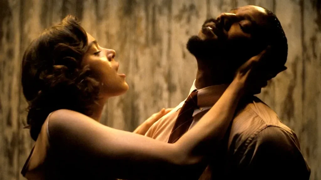 Hailee Steinfeld's vampire embracing Michael B. Jordan's character in a still from Sinners